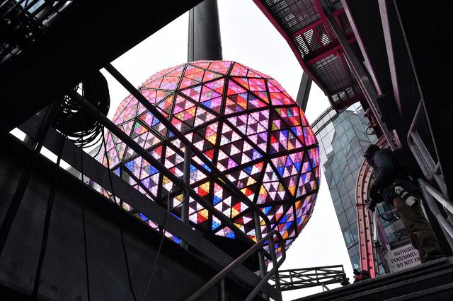 The glittering Times Square New Year's Eve Ball, illuminated in a multitude of colors, as seen from the rooftop of 1 Times Square